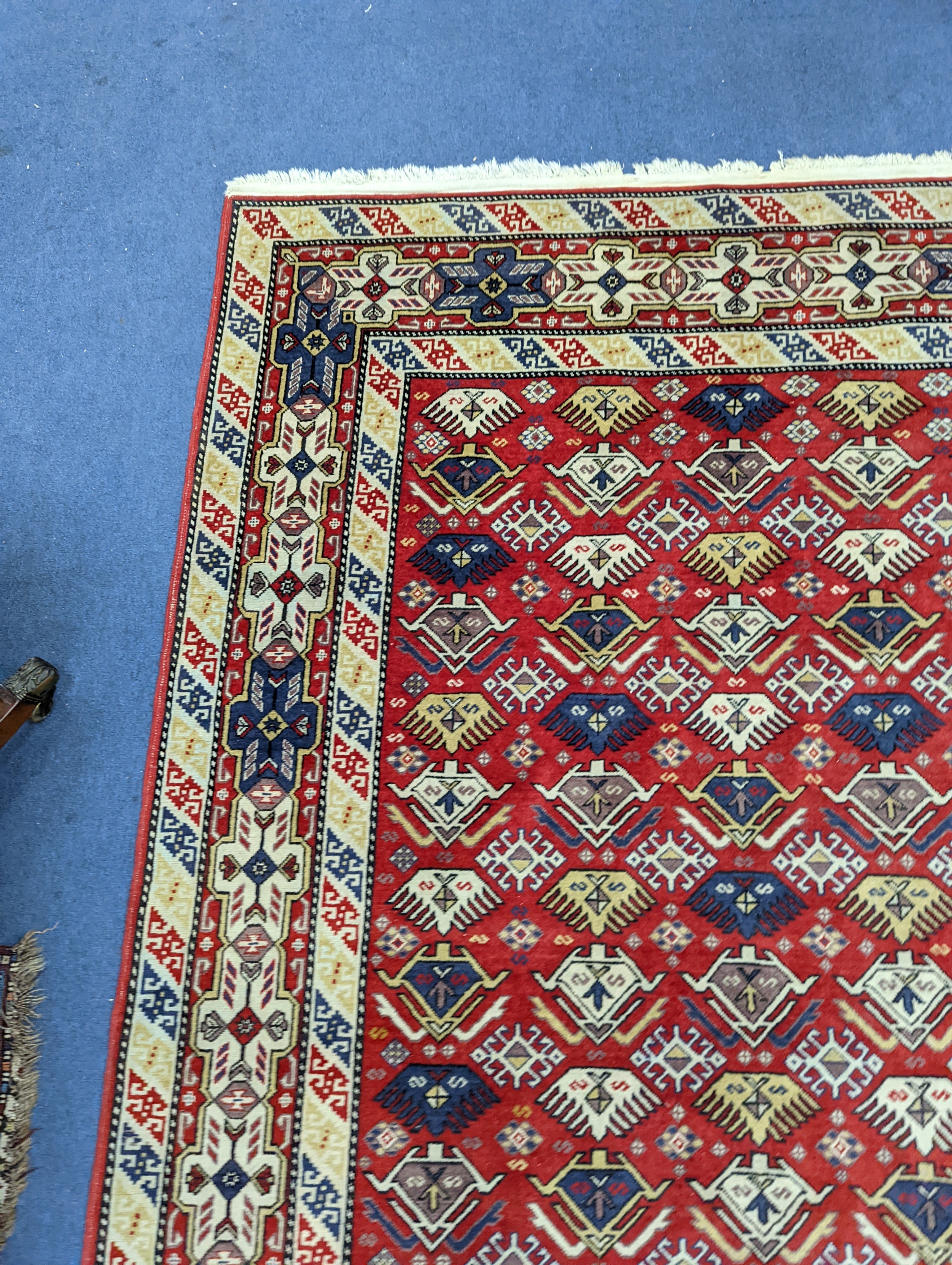 A Caucasian style red ground rug, 210 x 140cm